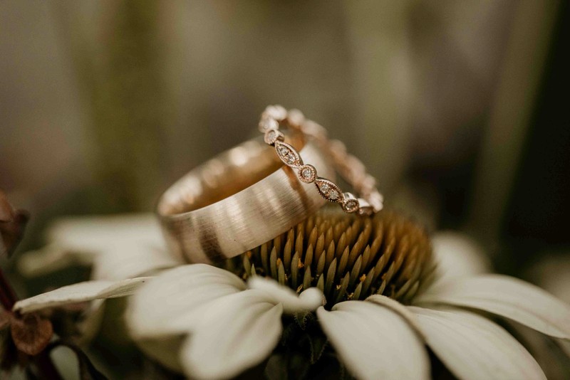 Bride and groom's wedding rings on a flower at Lake Tahoe